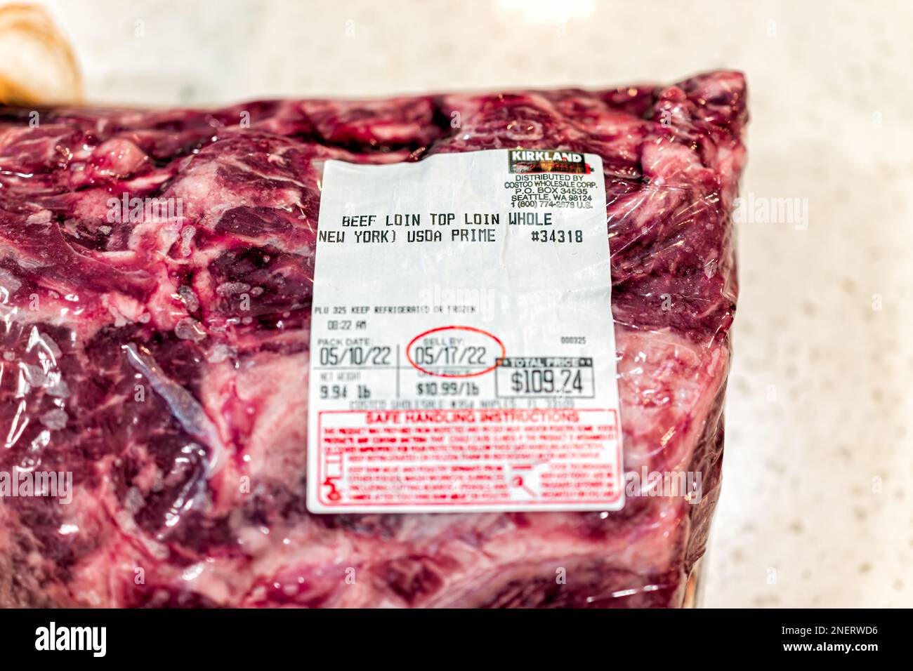 Naples, USA - May 11, 2022: Prime beef top loin sirloin meat steak as whole roast New York strip steak by Costco Kirkland brand with price and sell by Stock Photo