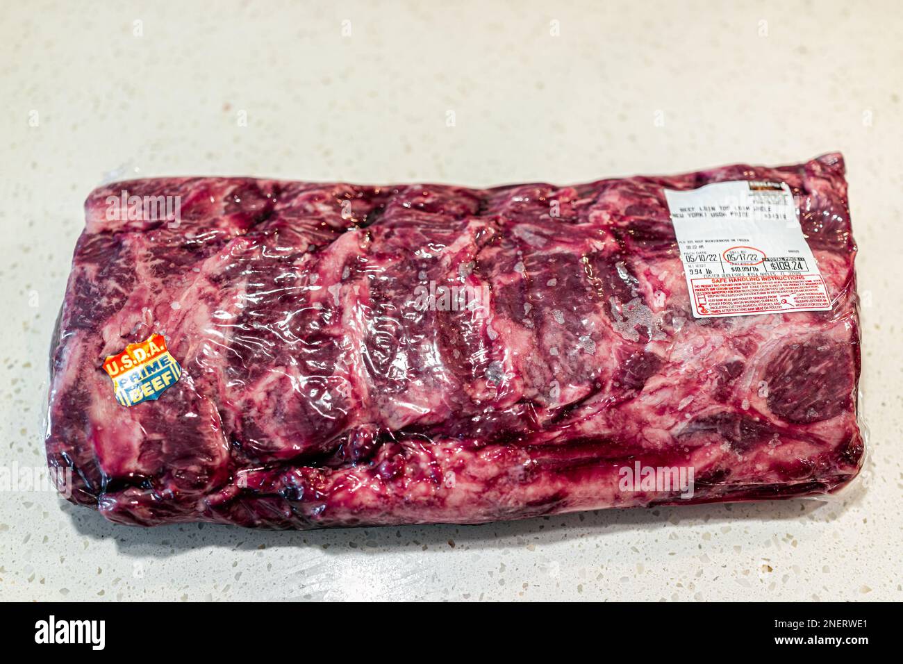 Naples, USA - May 11, 2022: Prime beef top loin sirloin meat steak as whole packaged roast New York strip steak by Costco Kirkland brand with price st Stock Photo