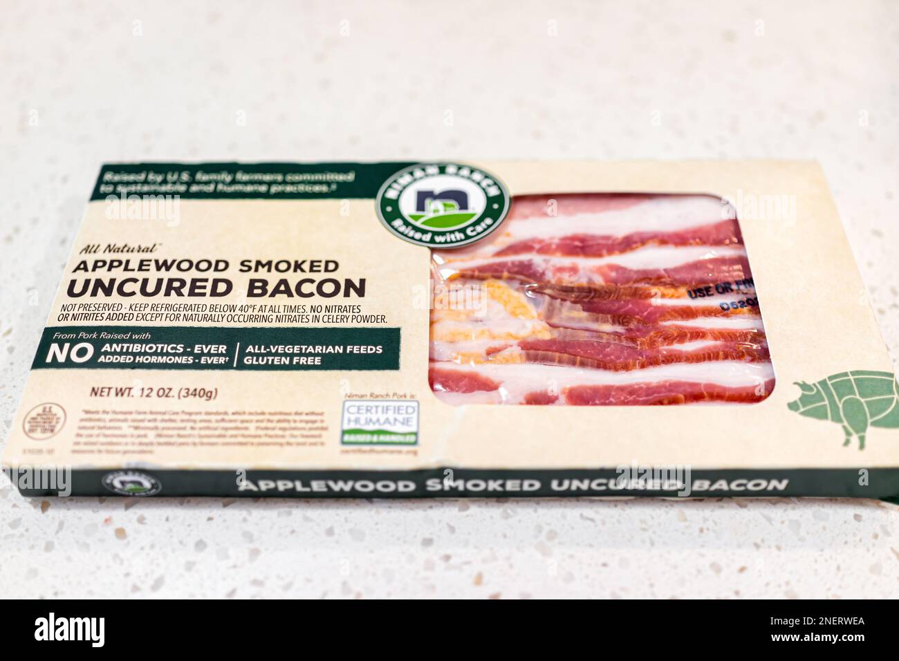 Naples, USA - May 11, 2022: Raw uncured applewood smoked bacon meat vacuum sealed label sign text packaged by Niman Ranch of humane practice closeup Stock Photo
