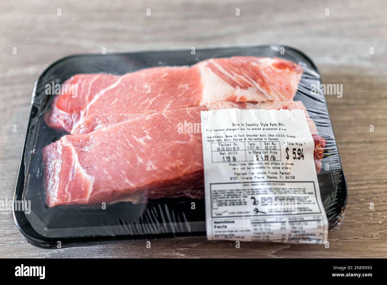 Naples, USA - May 27, 2022: Package product of raw bone-in country style pork ribs meat by Whole Foods Market butcher with price sign Stock Photo
