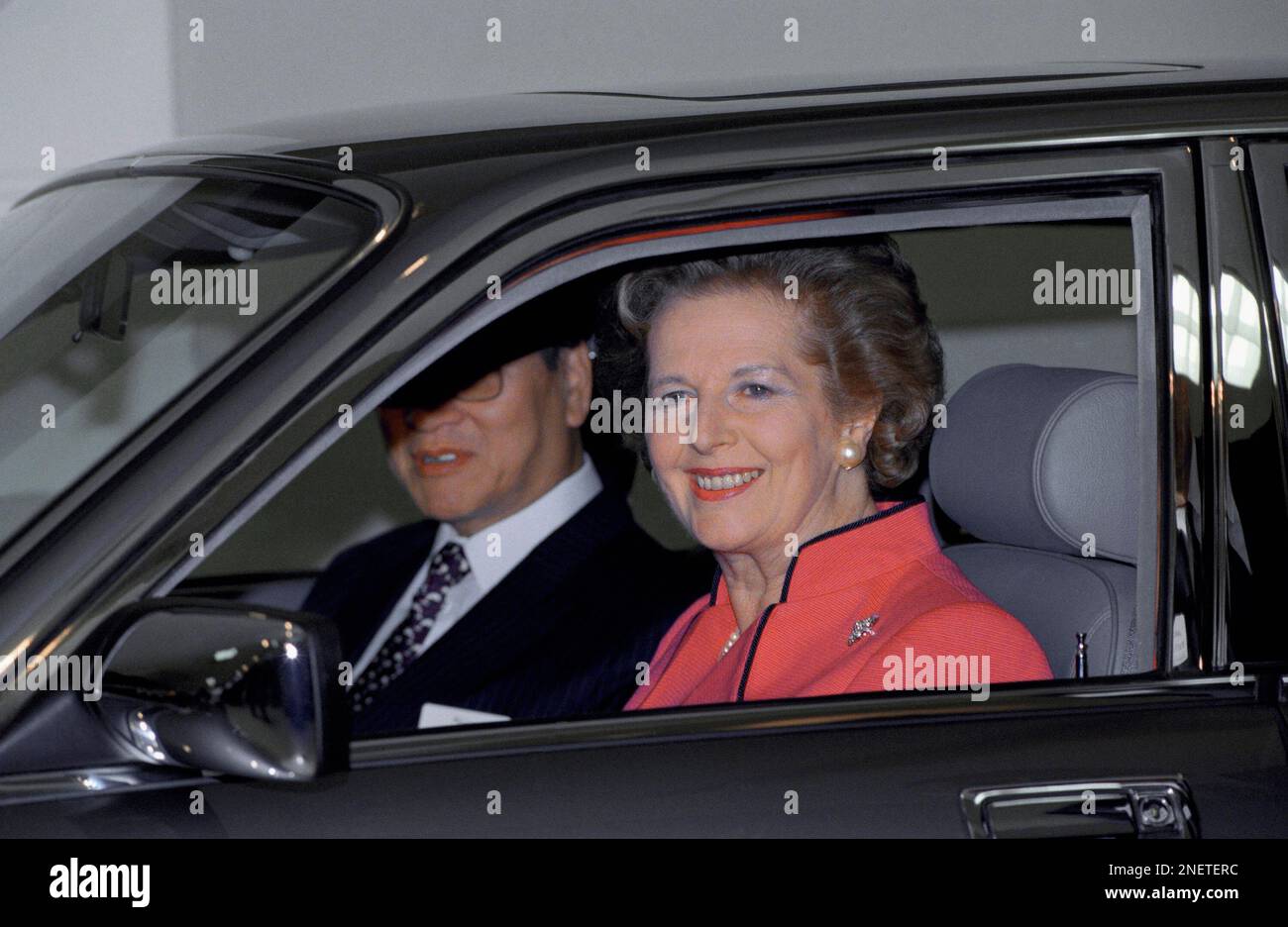 Prime Minister Margaret Thatcher of Britain smiles as she shares the front seat of a new model