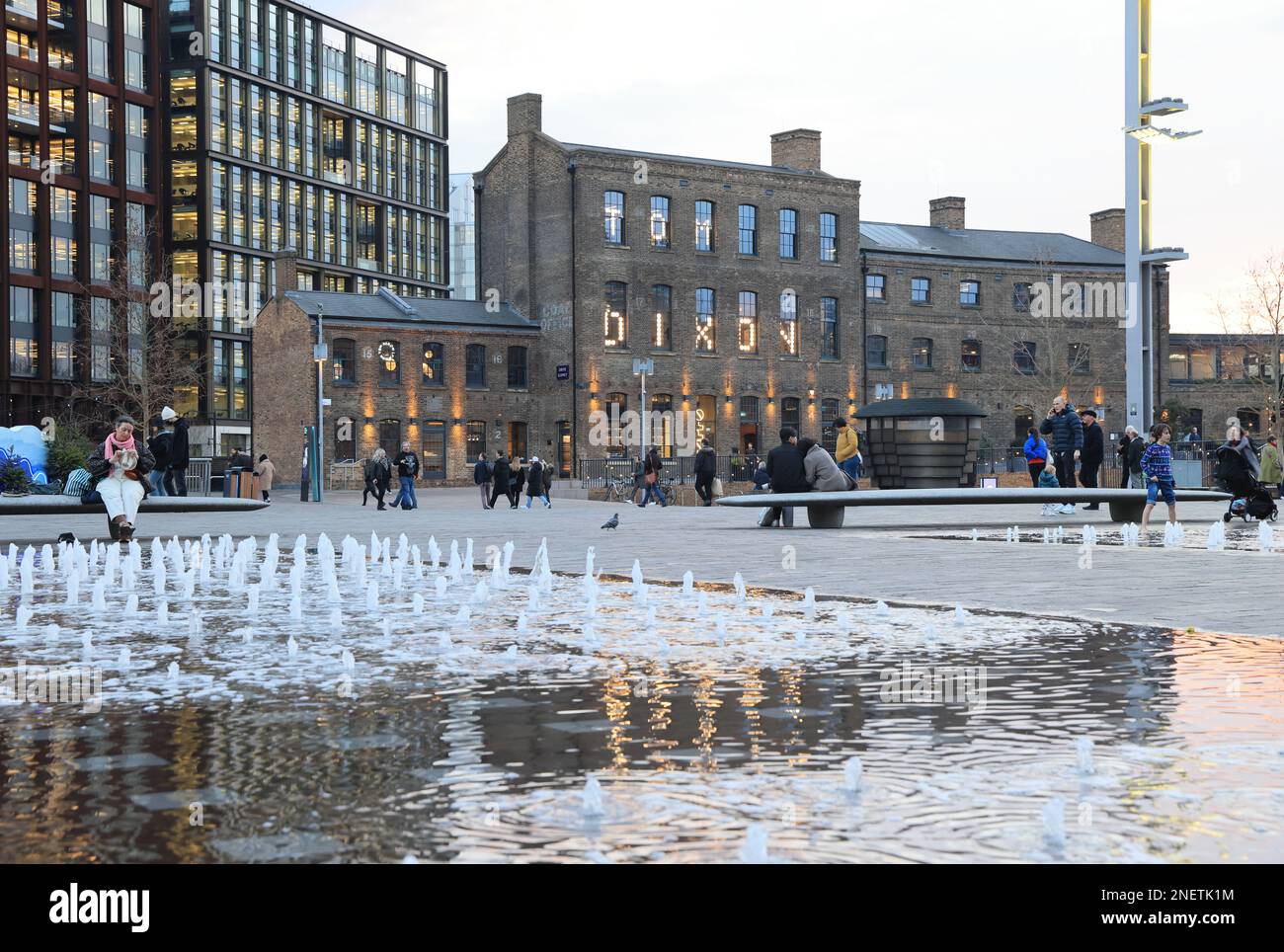 View across fountains in Granary Square, in late afternoon winter