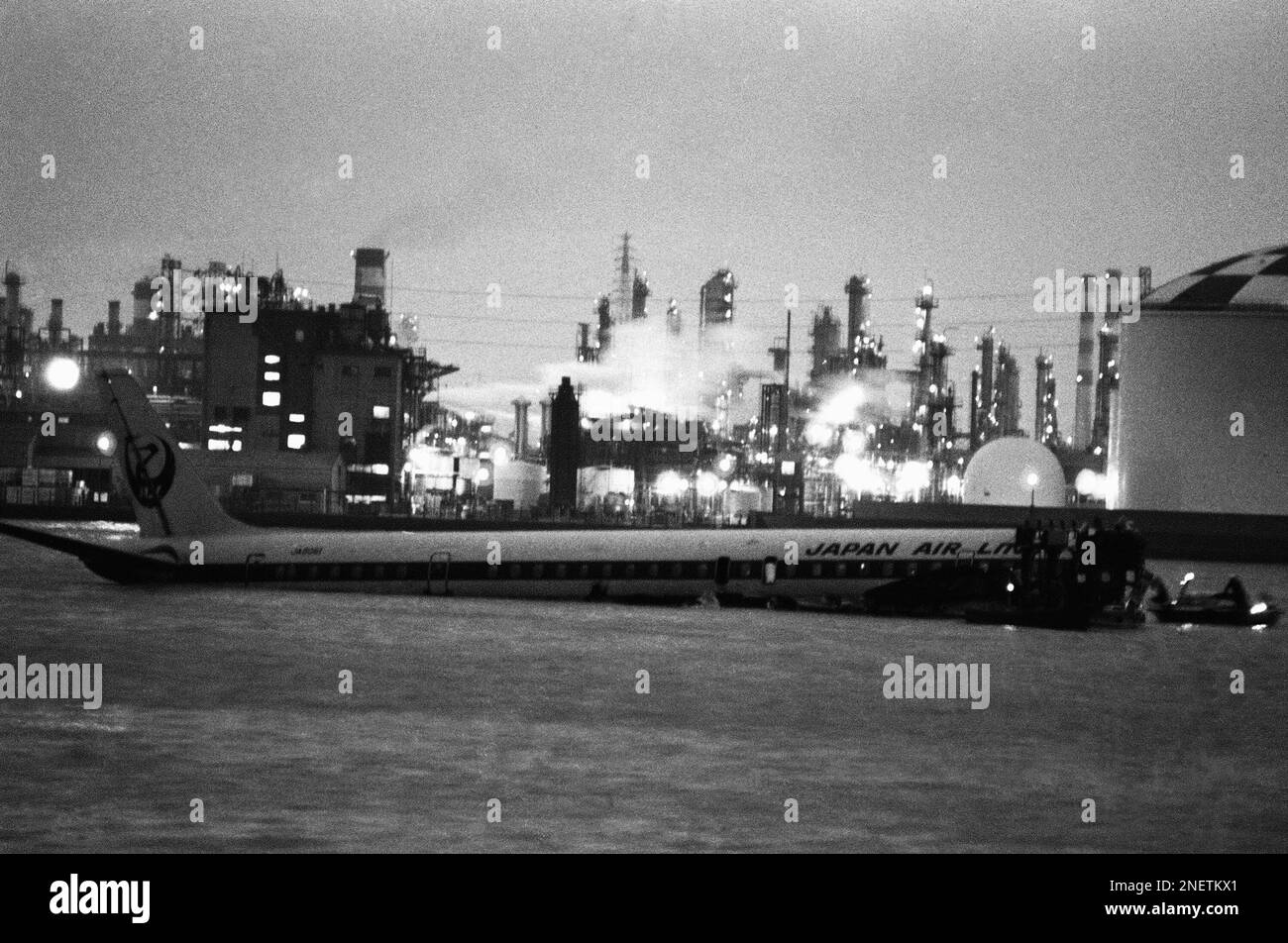 against-the-backdrop-of-an-oil-refinery-a-japan-air-lines-dc-8-with