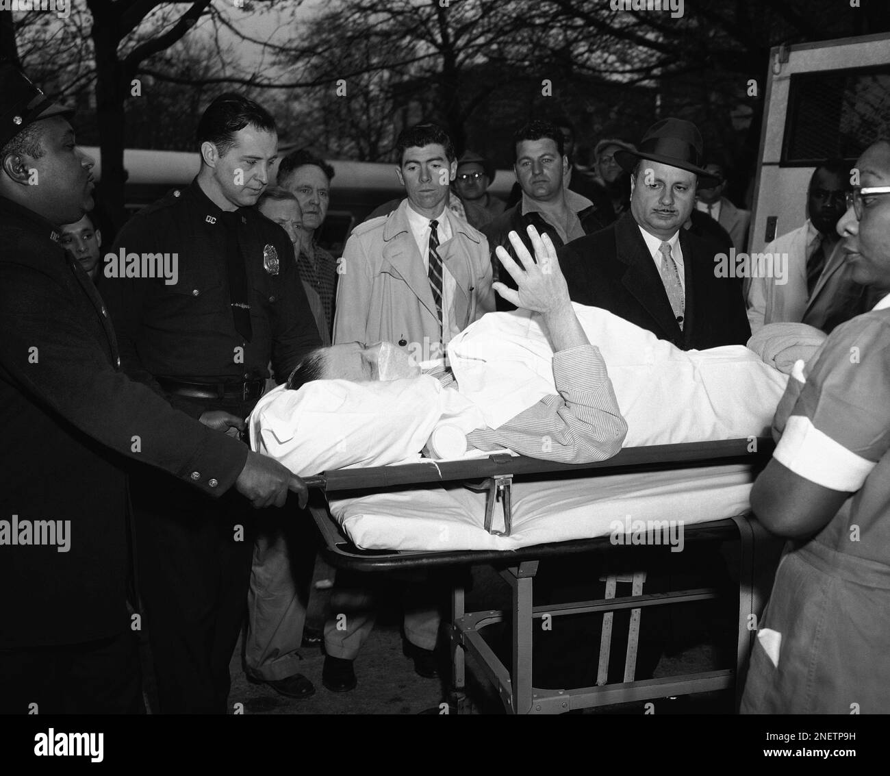 George Metesky, the mad bomber who planted 32 home made explosives in New  York public places over the past 16 years, waves feebly from his stretcher  as he is carried from Kings