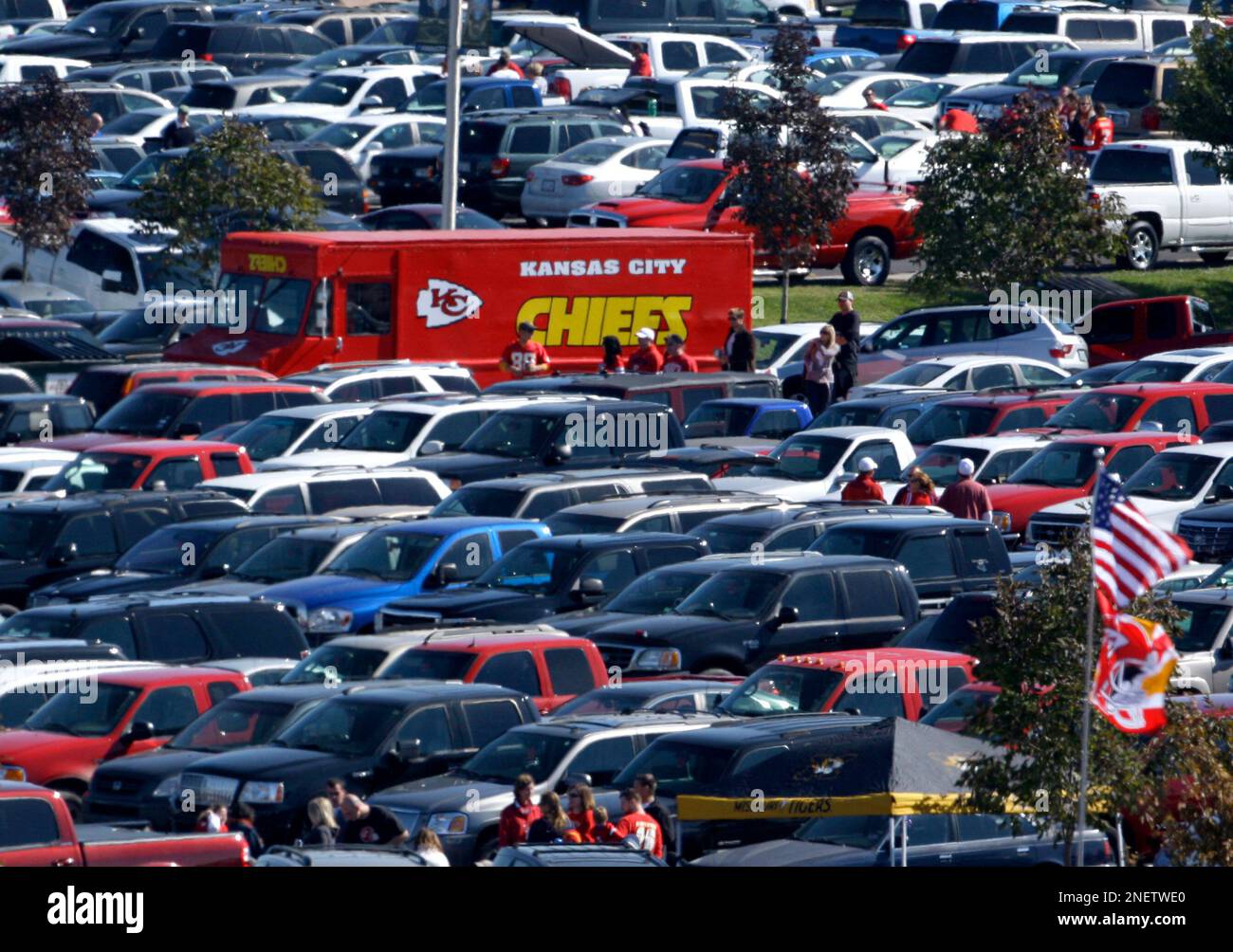 Cars are parked in a mostly empty parking lot at Arrowhead Stadium before  an NFL football game …