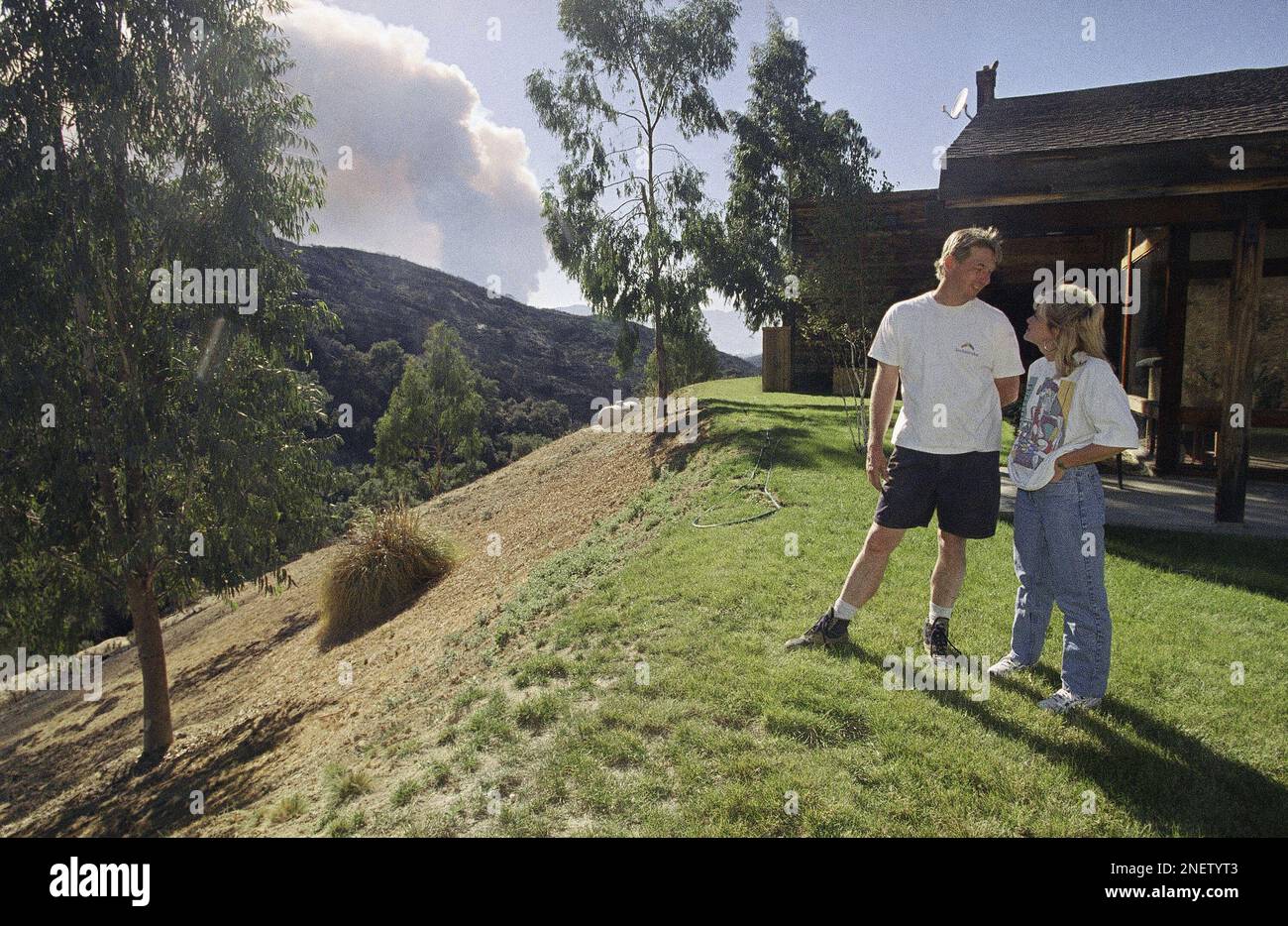 Don Helgesen and Tonya stand near their home in Stokes Canyon in