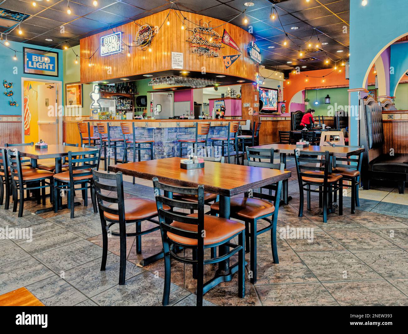 Mexican restaurant with a colorful bar with empty tables in Montgomery