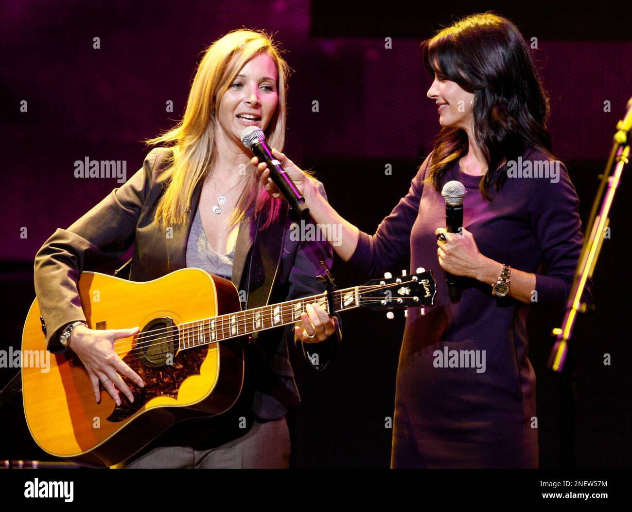Lisa Kudrow, left, performs "Smelly Cat" as Courteney Cox laughs during