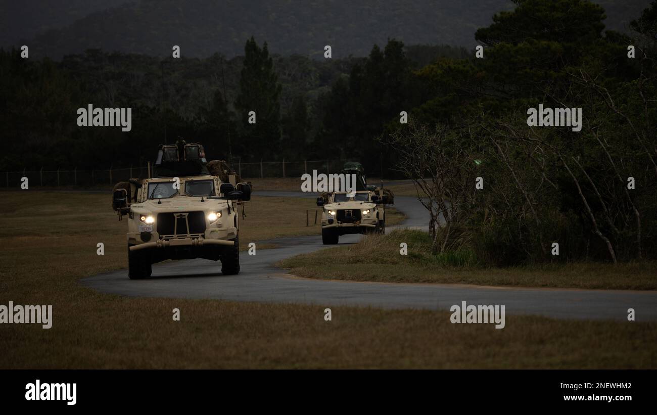 U.S. Marines with 1st Battalion, 7th Marines conduct a convoy using Joint Light Tactical Vehicles to reach an objective during Jungle Warfare Exercise 23 in the Northern Training Area on Okinawa, Japan, Feb. 14, 2023. JWX 23 is a large-scale field training exercise focused on leveraging the integrated capabilities of joint and allied partners to strengthen all-domain awareness, maneuver, and fires across a distributed maritime environment. (U.S. Marine Corps photo by Lance Cpl. Noah Masog) Stock Photo