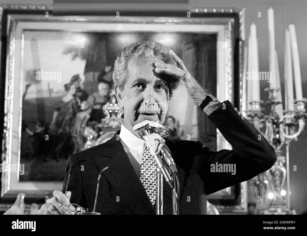 Fashion designer Mr. Blackwell holds photos of those included on his