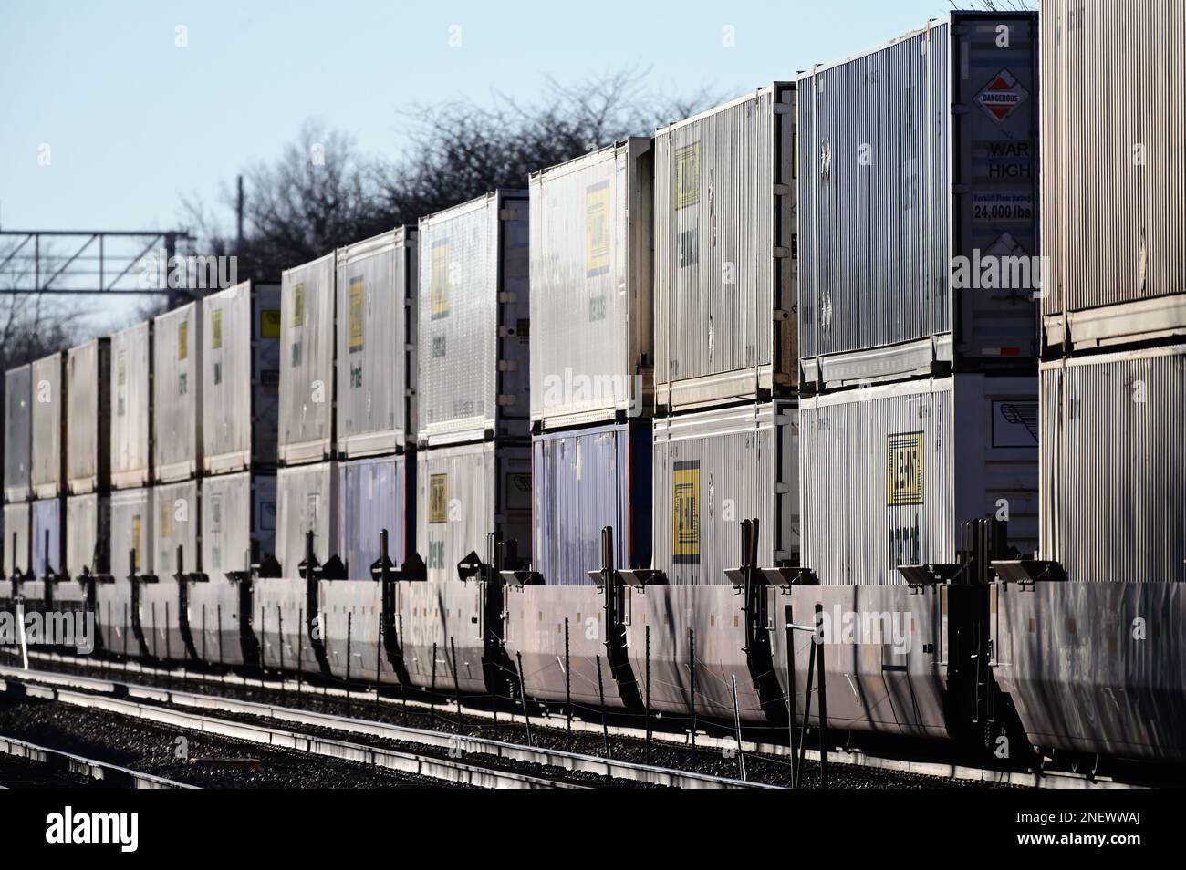 Naperville, Illinois, USA.  An intermodal freight train from Chicago reflects the late afternoon sun as it passes through northeastern Illinois. Stock Photo