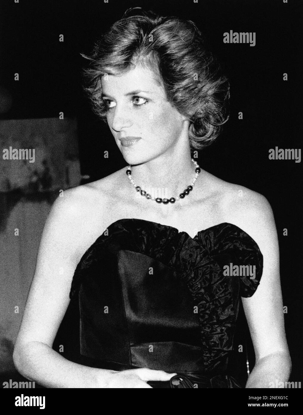 princess diana strapless black dress March 9, 1981: Diana wears a strapless black taffeta dress designed by David and Elizabeth Emanuel to her first Royal Engagement as the future Princess of Wales. The gown immediately captured