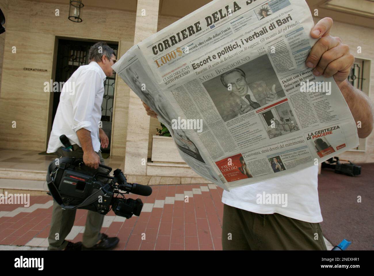 Journalists and media crews are seen in front of a crematorium in Monte