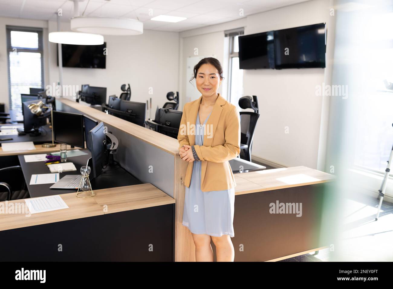 Happy asian businesswoman looking at camera in office Stock Photo