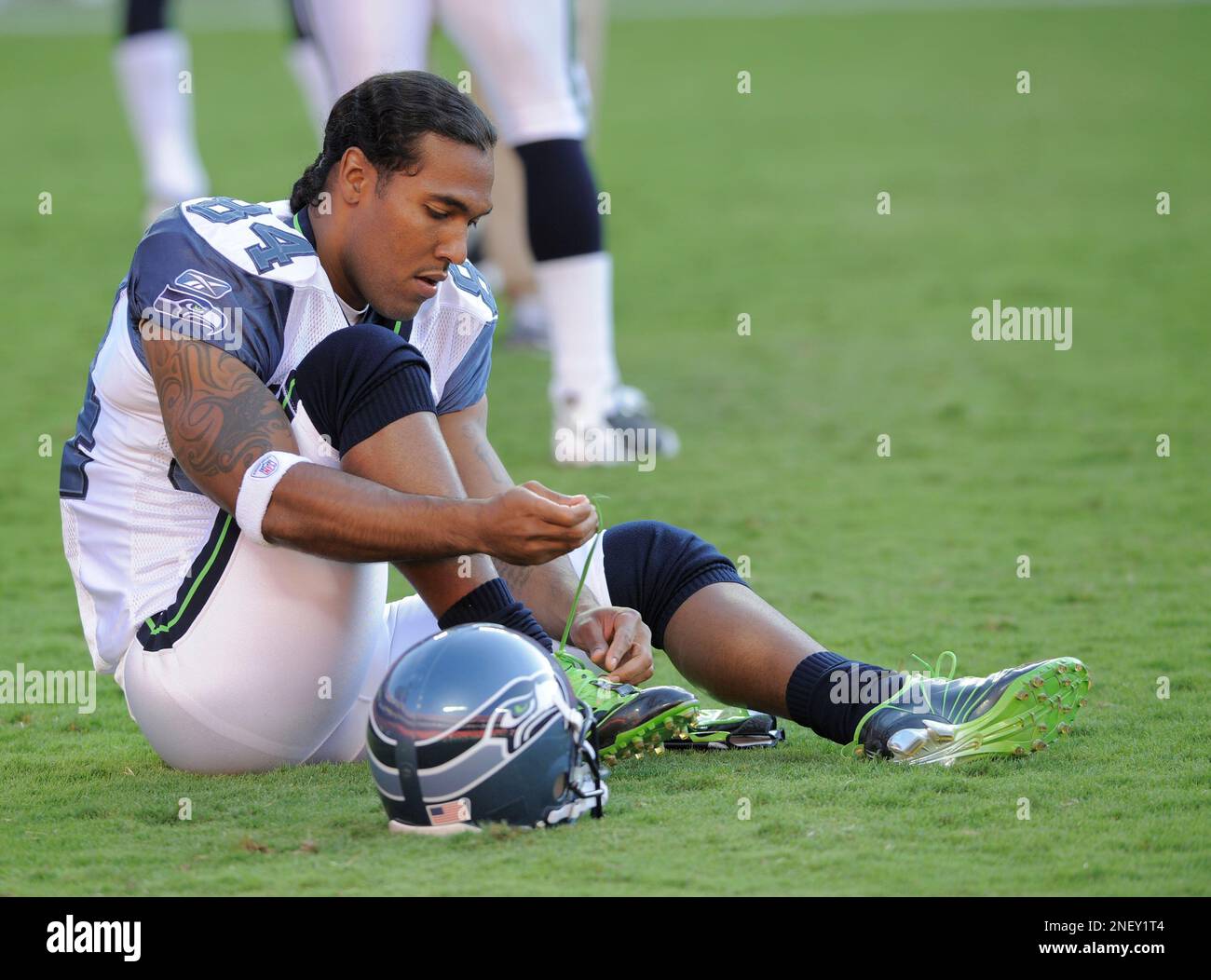 Seattle Seahawks wide receiver T.J. Houshmandzadeh ties his shoes before a  preseason NFL football game against the Kansas City Chiefs Saturday, Aug.  29, 2009 in Kansas City, Mo. (AP Photo/Reed Hoffmann Stock