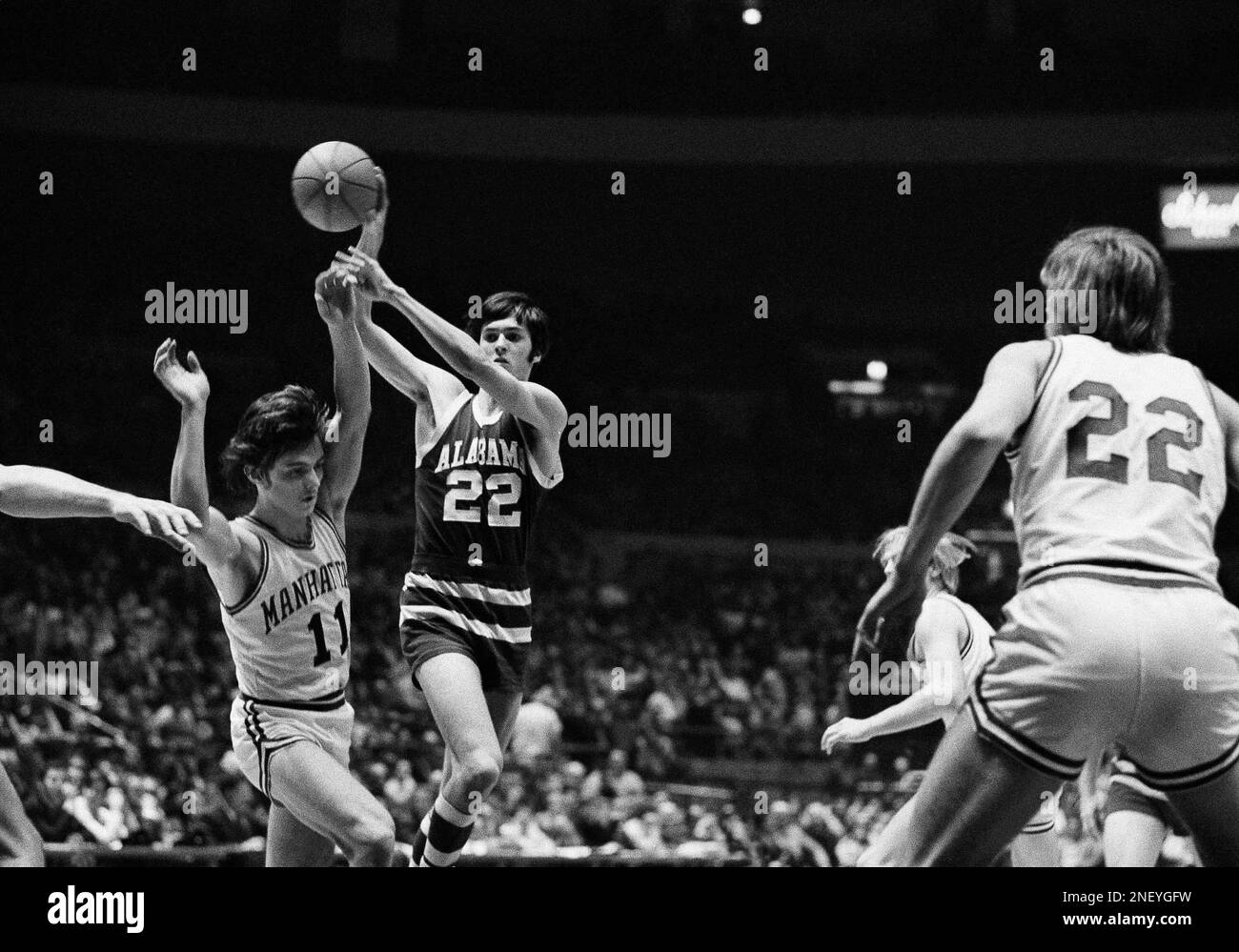 Johnny Dill (22) of Alabama is about to pass the ball over the head of