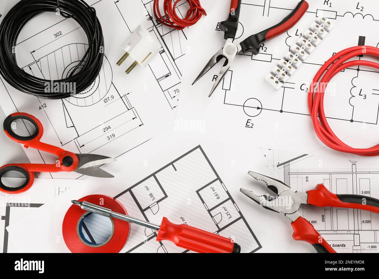 Flat lay composition with electrician's tools and house plan sheets on