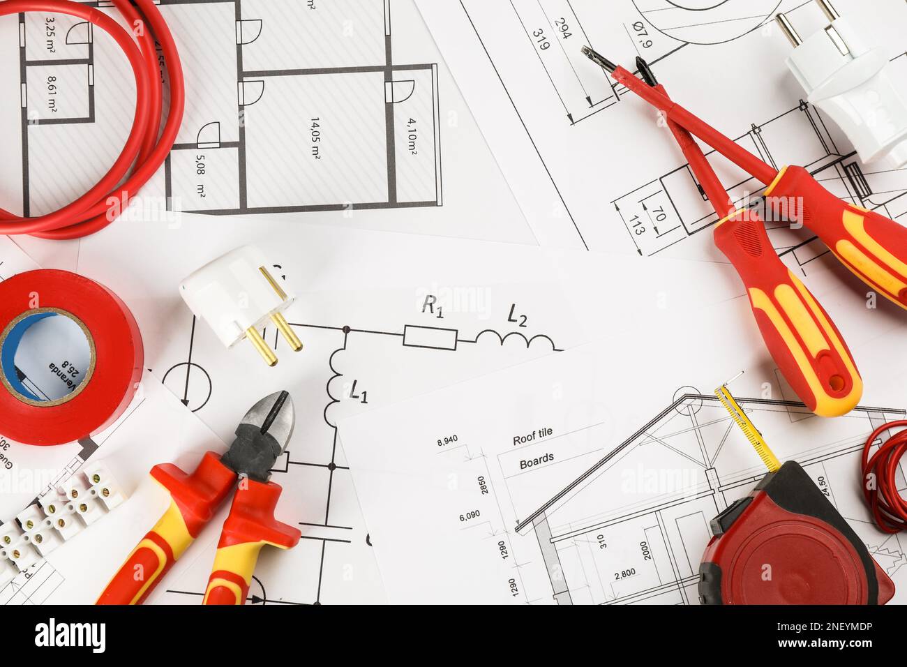 Flat lay composition with electrician's tools on house plan sheets