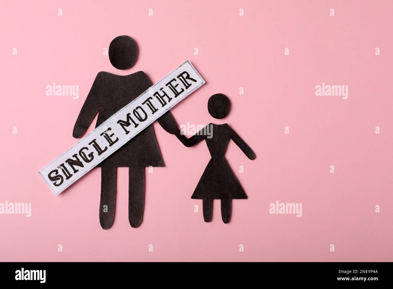 Being single mother concept. Woman with her child made of paper on pink ...