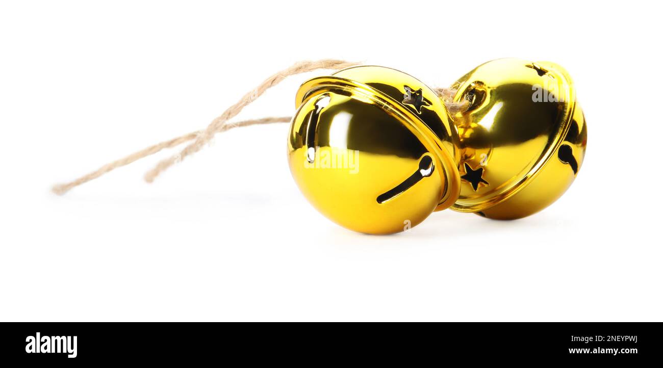 Shiny golden sleigh bells on white background Stock Photo - Alamy