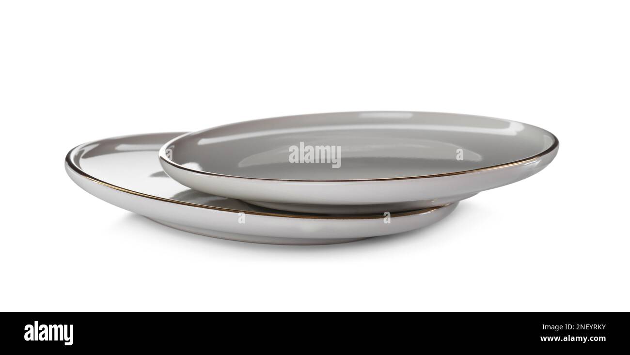 Clean empty ceramic plates on white background Stock Photo - Alamy