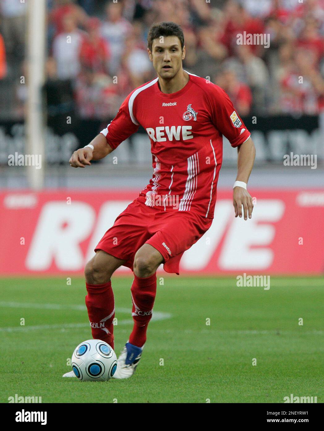 Cologne's Kevin Pezzoni goes with the ball during the German first division Bundesliga soccer match between FC Cologne and VfL Wolfsburg in Cologne, Germany, Saturday, Aug. 15, 2009. (AP Photo/Hermann J. Knippertz) **Eds Note: German spelling of Cologne is Koeln** Stock Photo