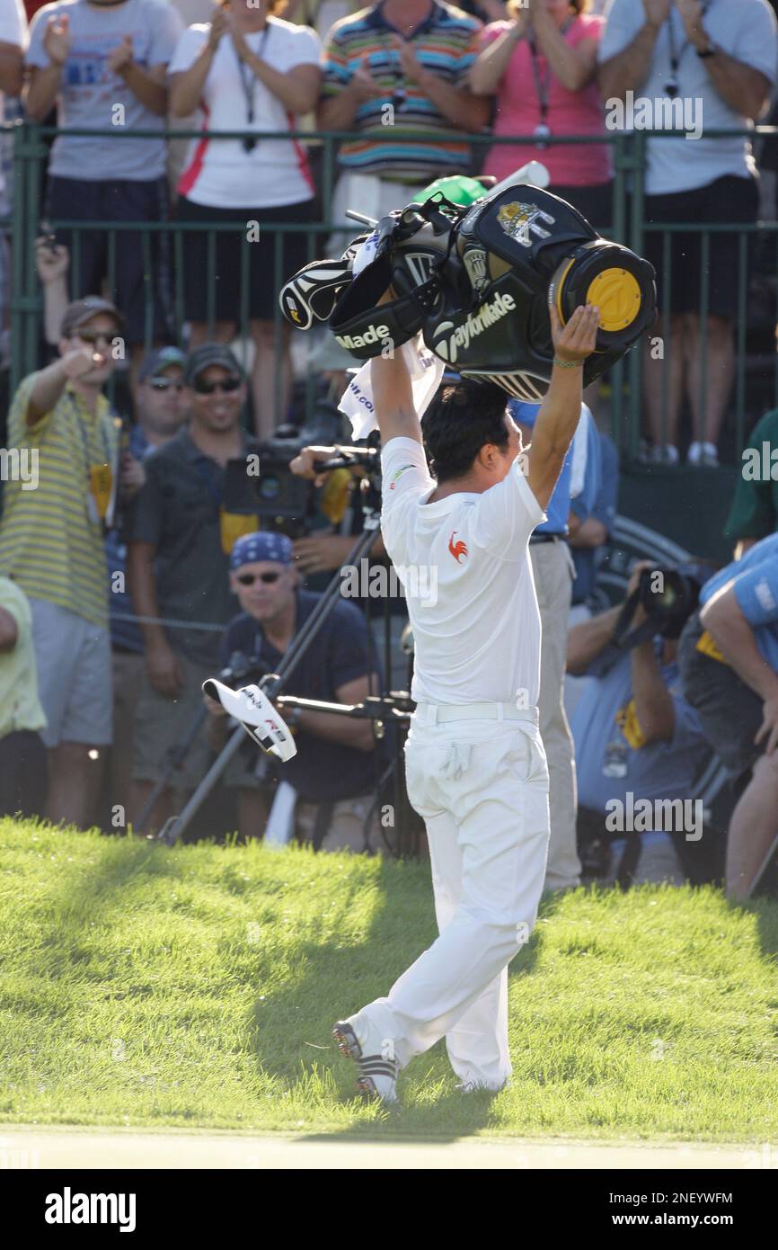 Y.E. Yang, of South Korea, lifts his golf bag after winning the 91st ...