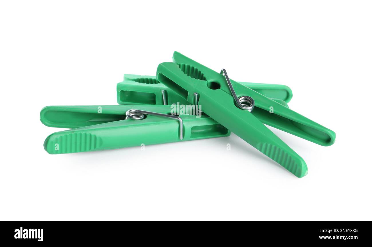 Bright green plastic clothespins on white background Stock Photo Alamy