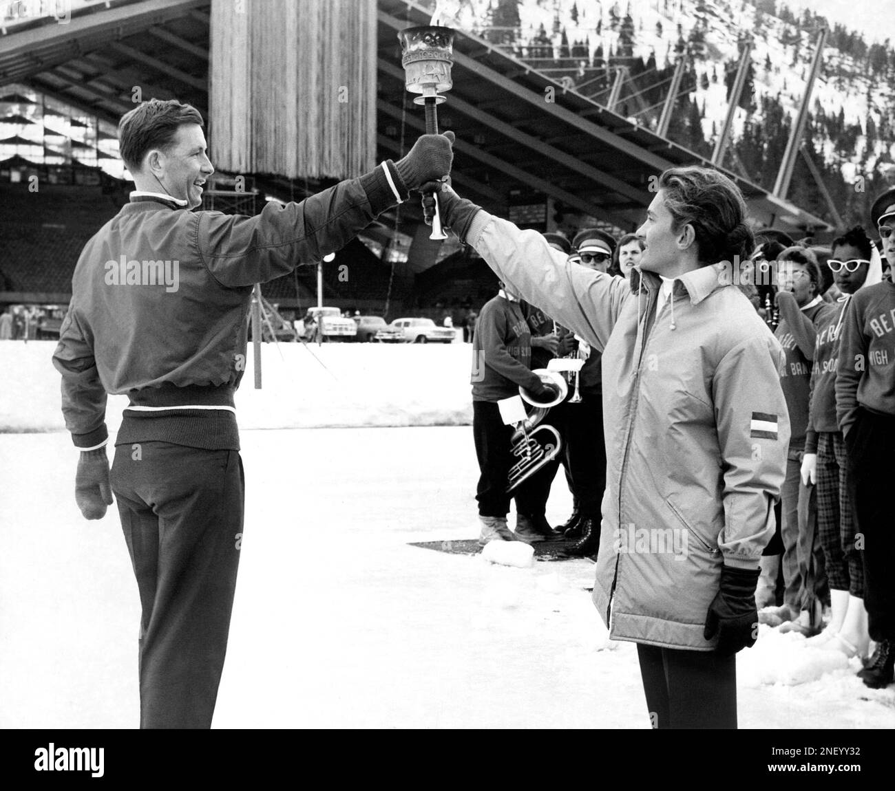 andrea-mead-lawrence-right-passes-the-olympic-torch-to-speed-skater