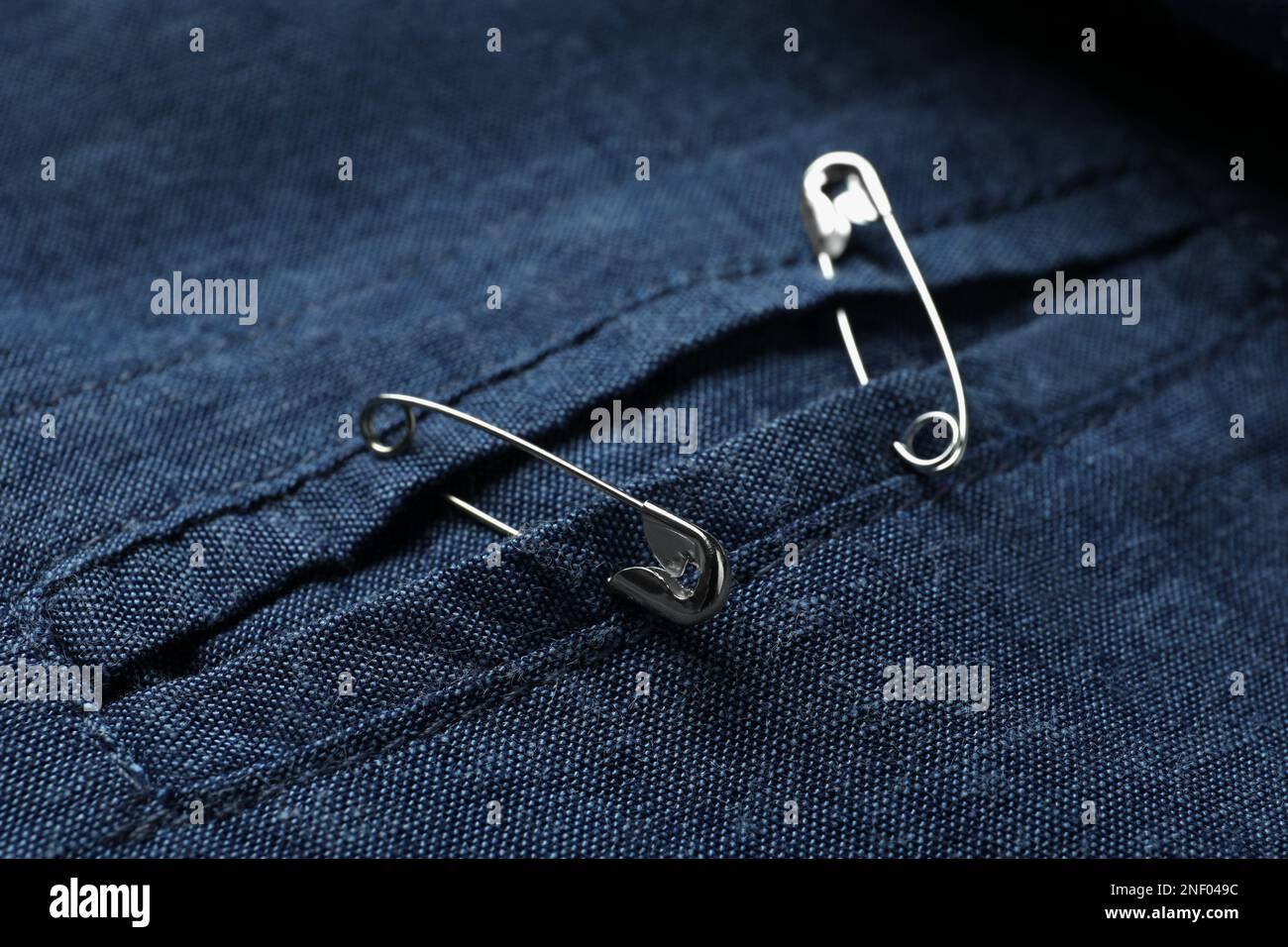 Closeup view of metal safety pins on clothing Stock Photo Alamy