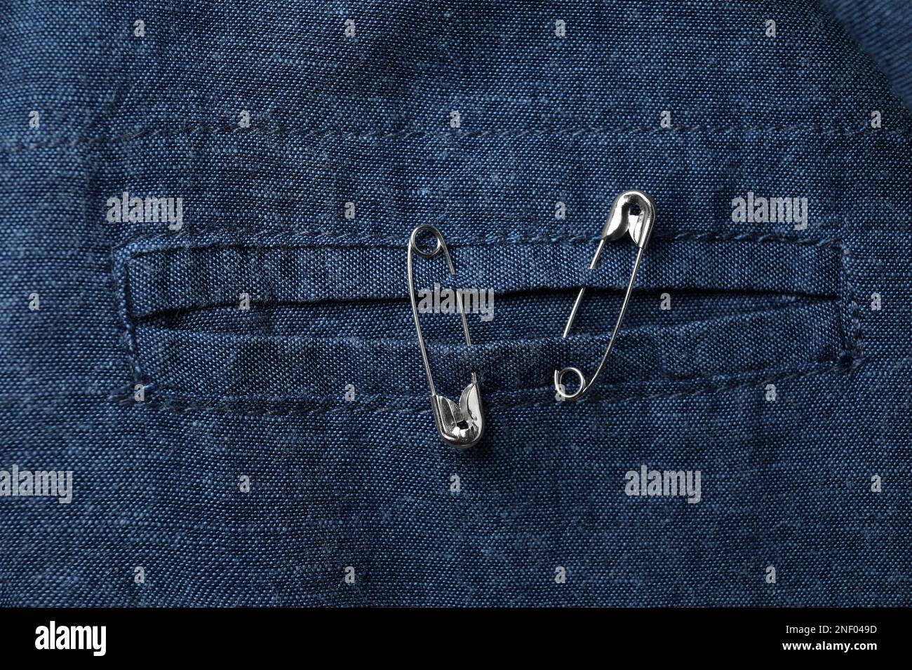 Top view of metal safety pins on clothing Stock Photo Alamy