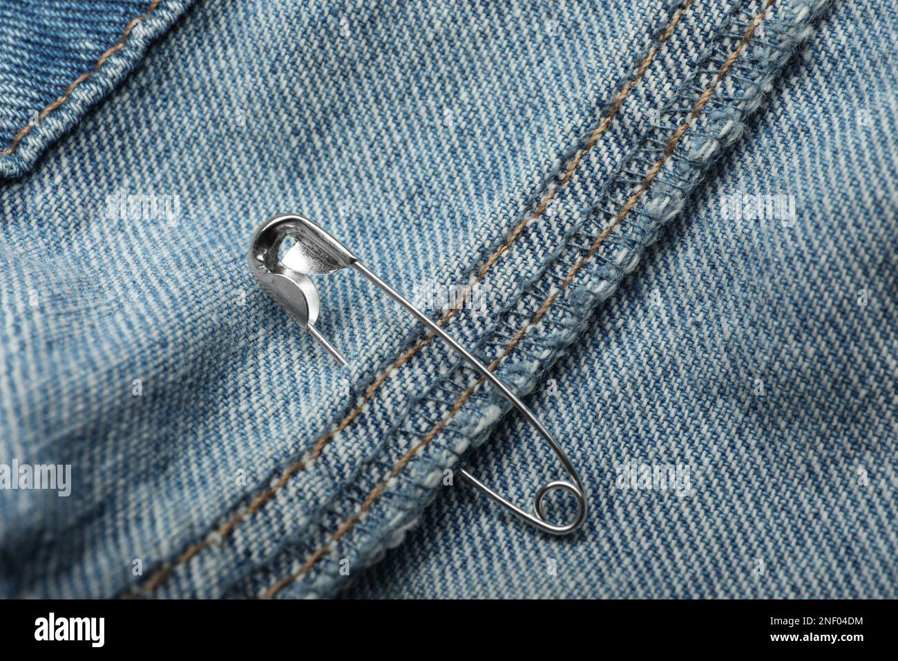 Closeup view of metal safety pin on clothing Stock Photo Alamy