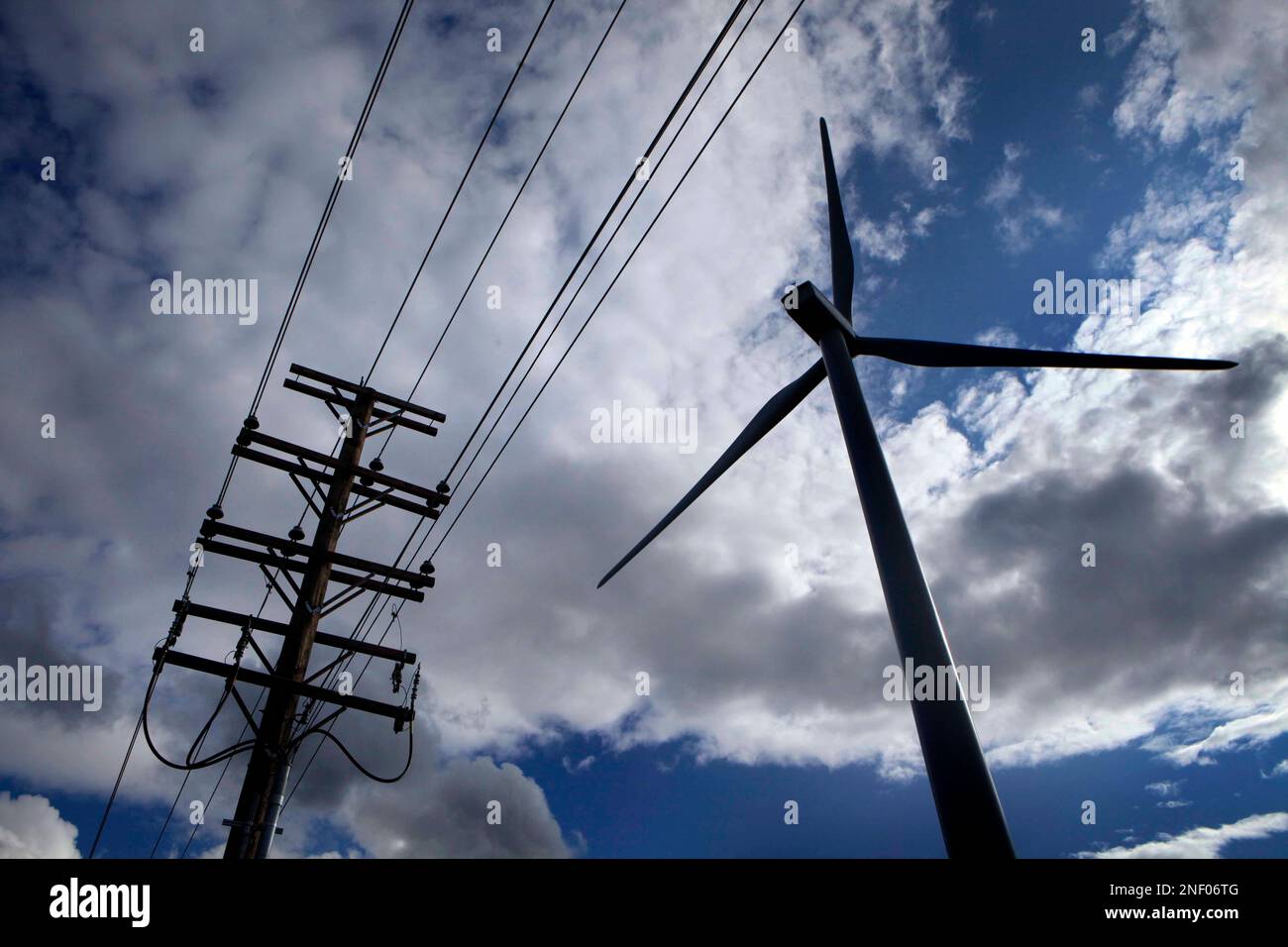 In this Tuesday, July 14, 2009 photo, a windmill and power lines are ...