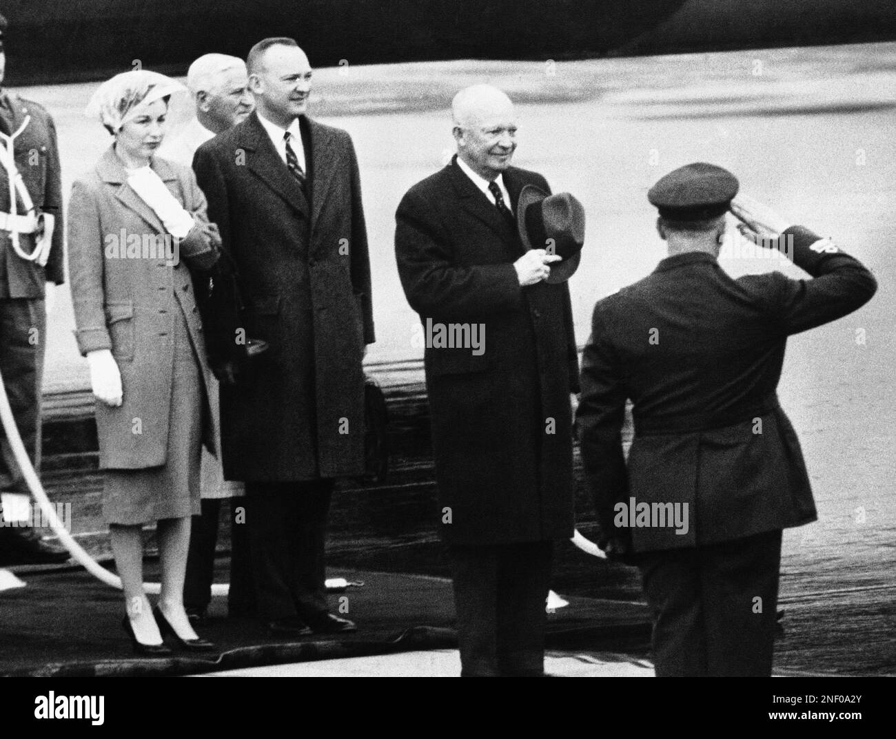 President Dwight Eisenhower stands bareheaded as United States and Italian Anthems are played on