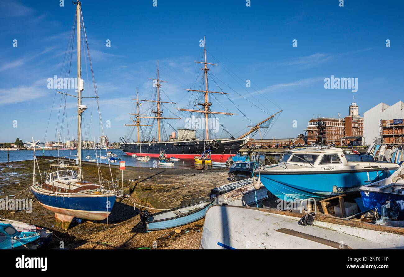 museum ship HMS Warrior at Portsmouth Historic Dockyard was the first steam-powered armoured frigate of the Royal Navy, seen from Common's shorline Ha Stock Photo