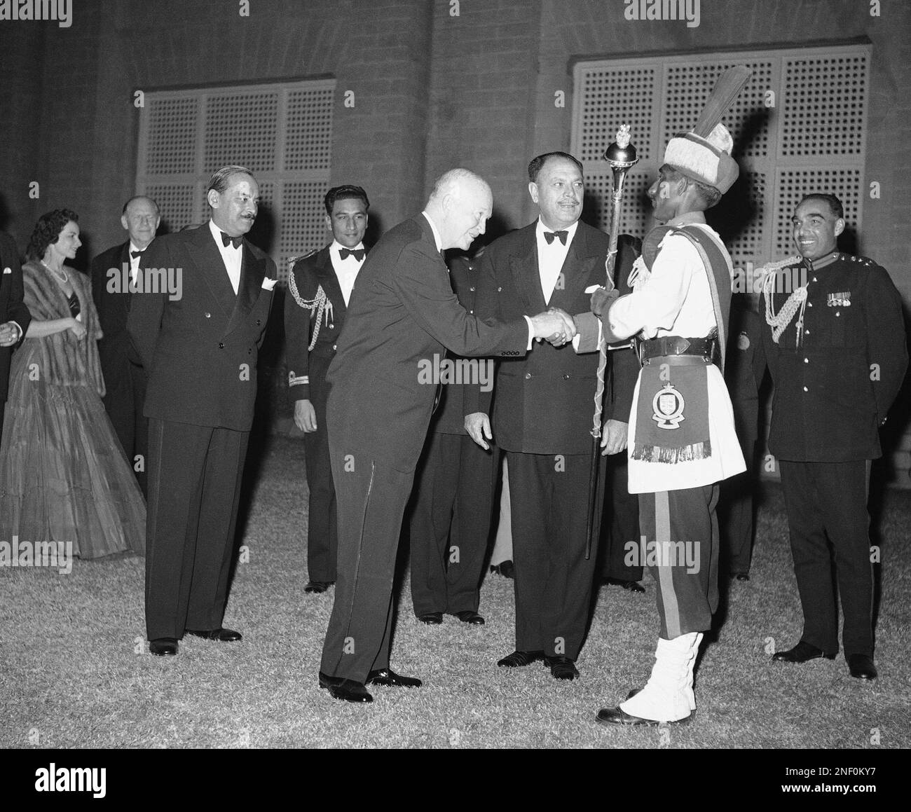 President Eisenhower shakes hands with colorfully garbed drum major of