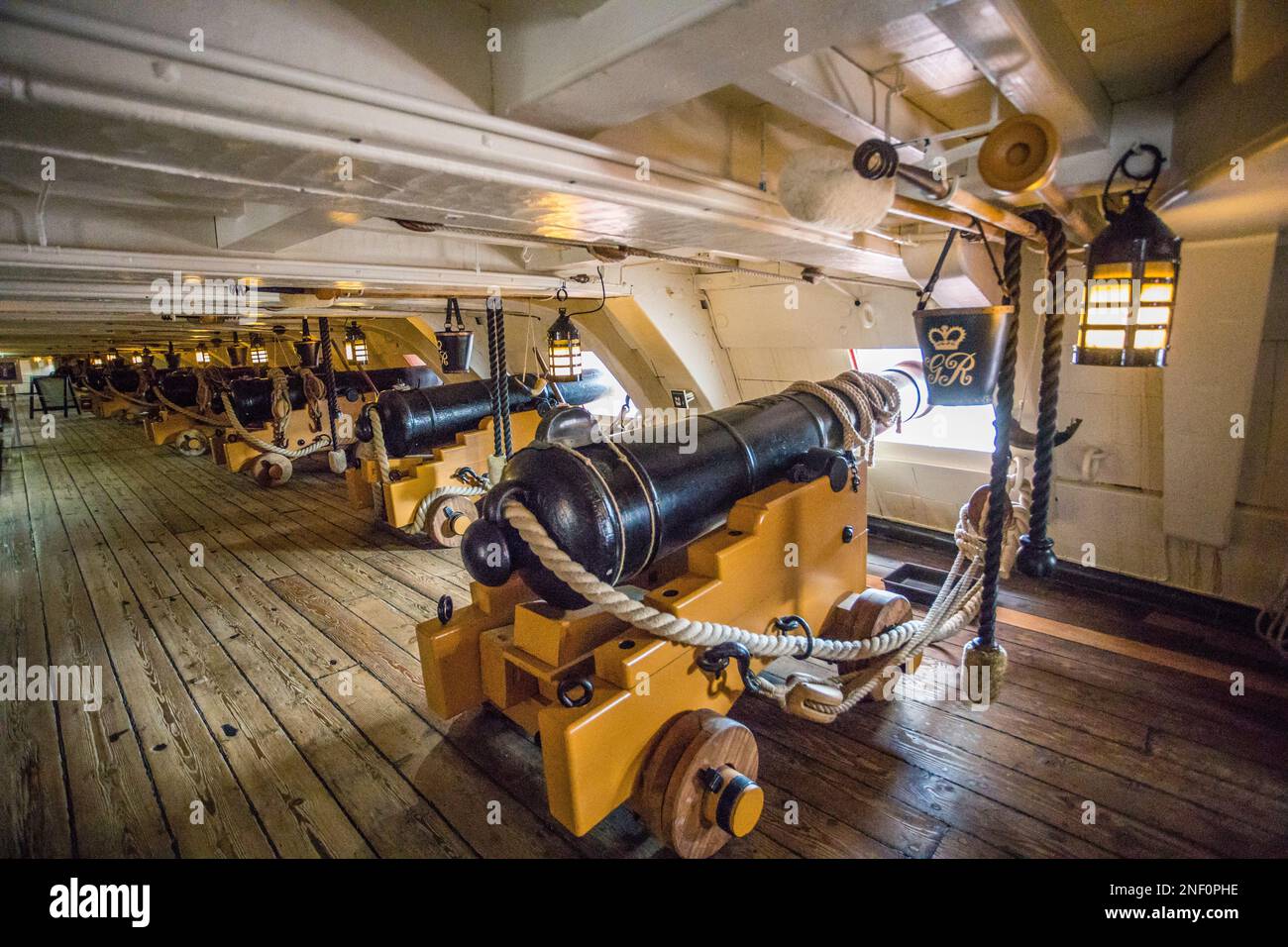 massive 32-pounder guns on the Lower Gun Deck of HMS Victory, museum ship at at Portsmouth Historic Dockyard, Hampshire, South East England Stock Photo