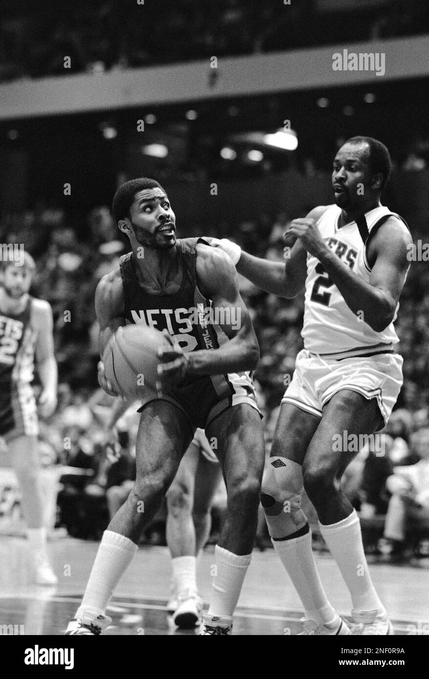 New Jersey Nets Buck Williams, left, looks for room to shoot around  Philadelphia 76ers Moses Malone in the first half of NBA play on Saturday,  March 22, 1986 in Philadelphia. (AP Photo/Peter
