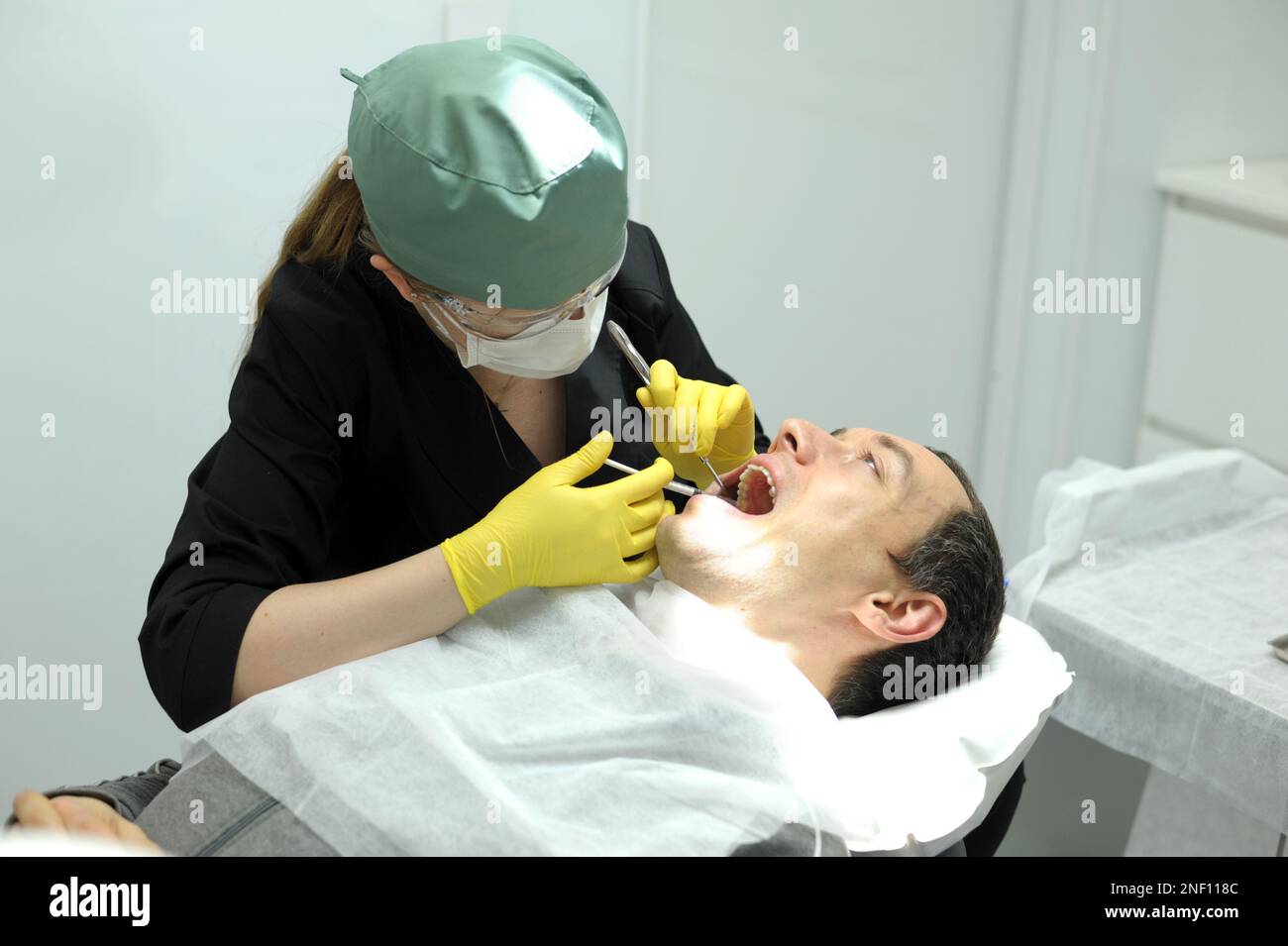 dental anesthesia in dentist's chair, needle of syringe, infiltration