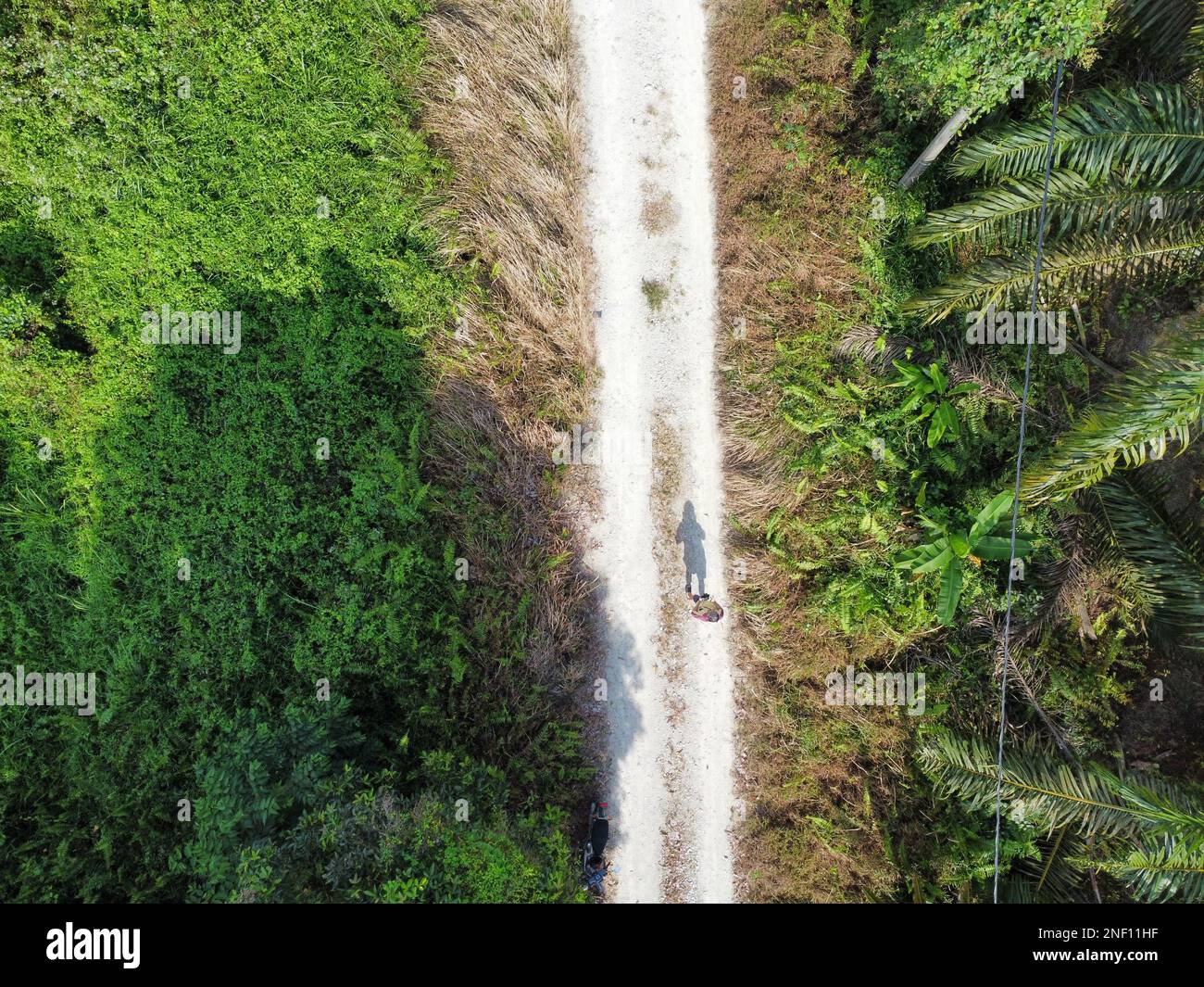 aerial shoot of the distance unrecognizable man walking alone on the ...