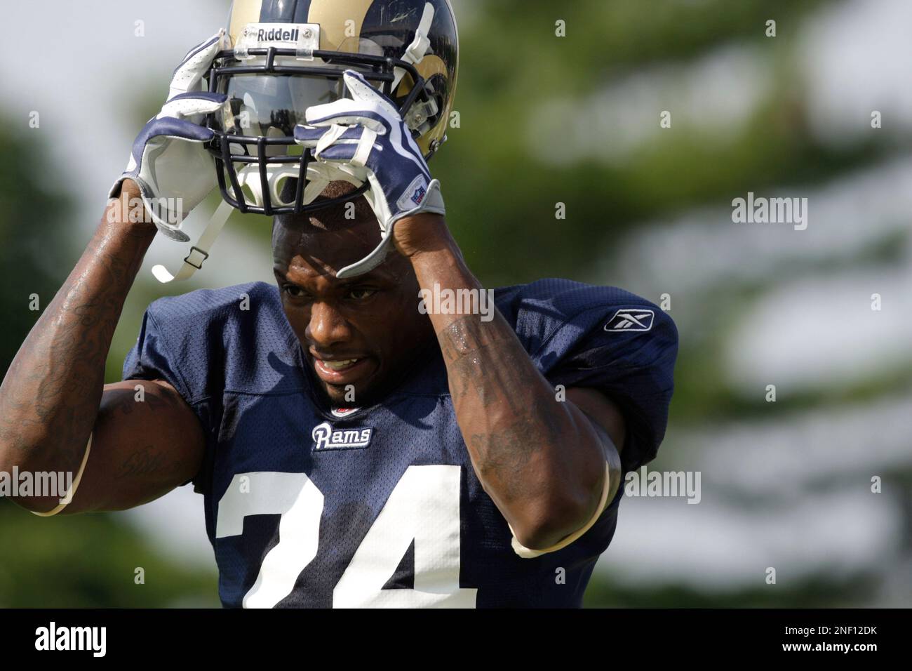 St. Louis Rams cornerback Ronald Bartell puts on his helmet during NFL  football training camp Saturday, Aug. 1, 2009, at the Rams' training  facility in St. Louis. (AP Photo/Jeff Roberson Stock Photo 