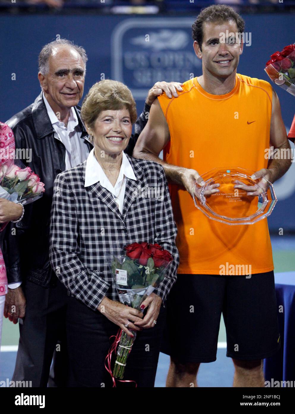 Pete Sampras, right, of the United States, poses with his parents, Sammy and Georgia, after receiving a plate during a ceremony recognizing him as the tournament honoree at the L.A. Tennis Open, Monday, July 27, 2009, in Los Angeles. (AP Photo/Danny Moloshok) Stock Photo