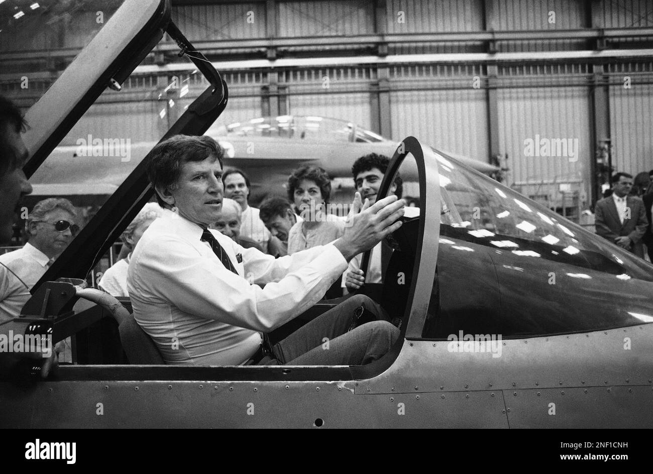 Senator Gary Hart, center, sits in the cockpit of Israel’s next generation fighter, the Lavi, during a tour of the works at the Israel Aircraft Industries plant, July 6, 1986, Tel Aviv, Israel. Next to the cockpit center is the Senator's wife Lee. (AP Photo) Stock Photo