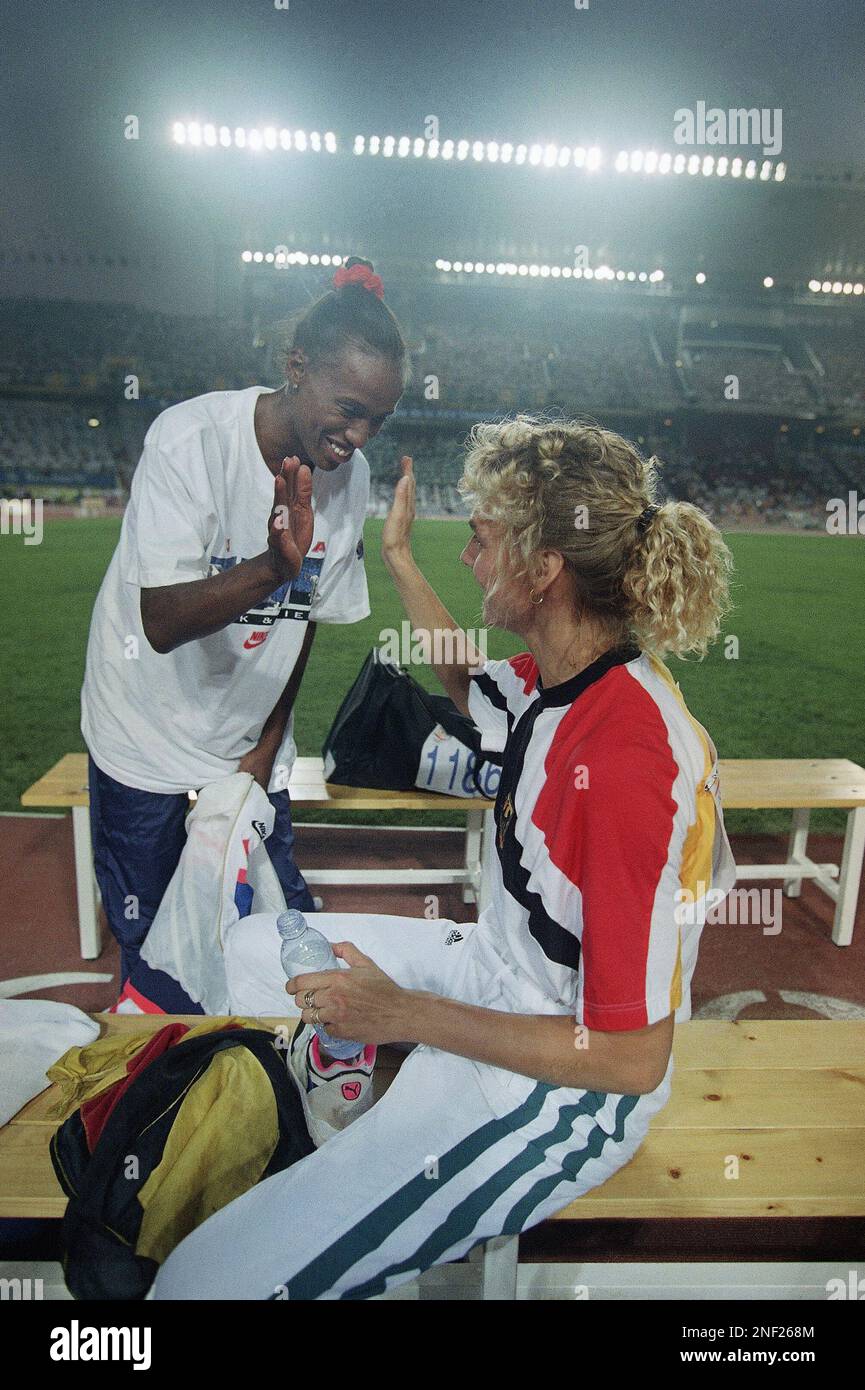 USA s Jackie Joyner Kersee Of Canoga Park Calif Top Gives A High usa-s-jackie-joyner-kersee-of-canoga-park-calif-top-gives-a-high