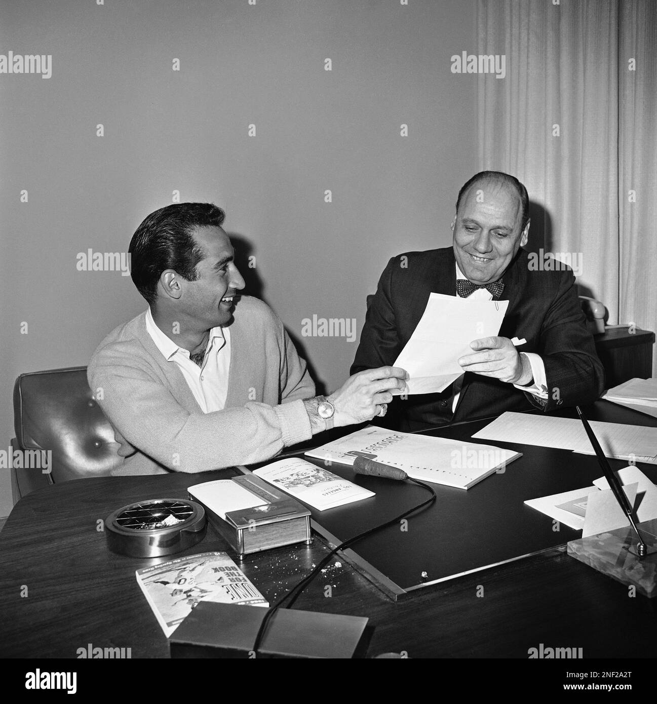 https://c8.alamy.com/comp/2NF2A2T/southpaw-sandy-koufax-demonstrates-for-the-benefit-of-photographers-how-he-signed-his-contract-for-1964-with-the-los-angeles-dodgers-after-he-and-general-manager-e-j-buzzy-bavasi-right-came-to-terms-following-a-three-hour-conference-feb-28-1964-in-los-angeles-sandy-signed-for-a-salary-reported-to-be-around-70000-sandy-said-he-planned-to-be-aboard-the-dodger-plane-when-it-leaves-for-spring-training-camp-in-florida-ap-photoed-widdis-2NF2A2T.jpg