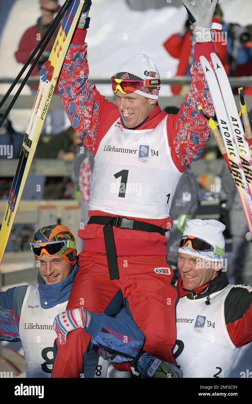 Norway's gold medal winner Bjorn Daehlie is hoisted on the shoulders of  Italy's bronze medalist Silvio Fauner, left, and Kazakhstan's silver medal  winner Vladimir Smirnov for the benefit of photographers following the
