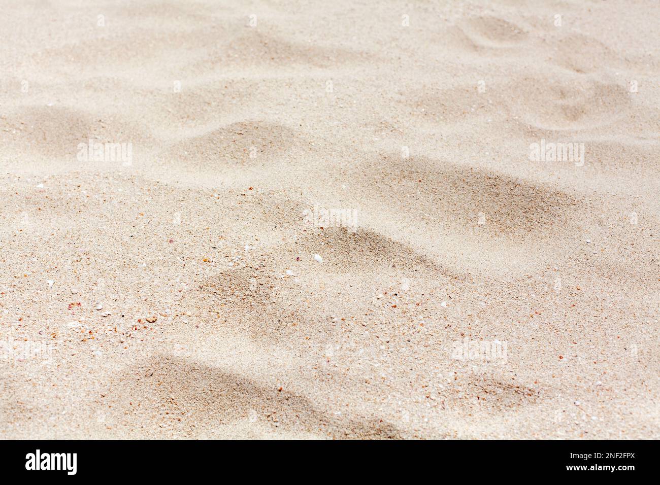 White sand texture close up background, wavy sandy pattern, natural dry sand grains backdrop, clean beige rippled sand surface top view, desert dune Stock Photo