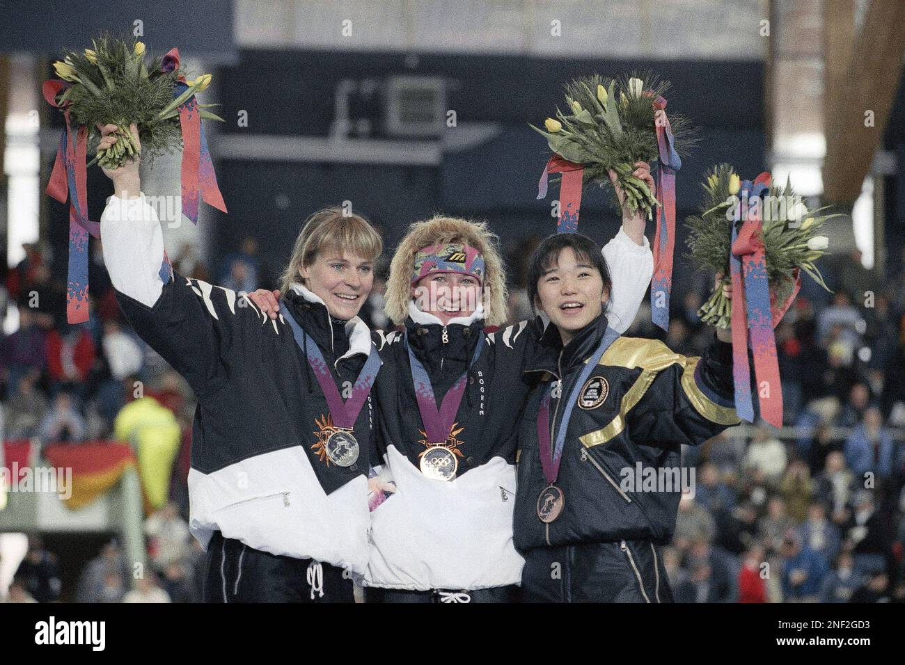 Waving from the medal podium are from left, German silver and gold, Gunda Niemann and Claudia ...