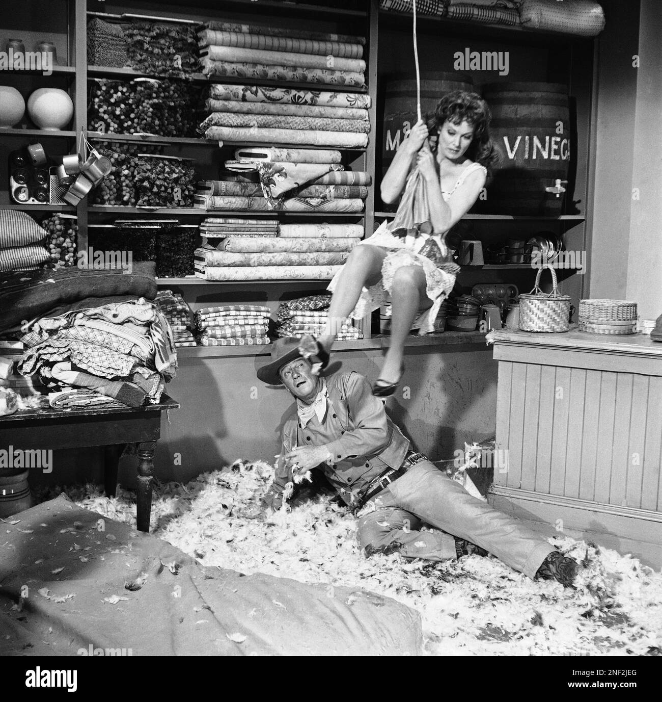 Maureen O'Hara, clad in pantaloons, swings over John Wayne in scene ...