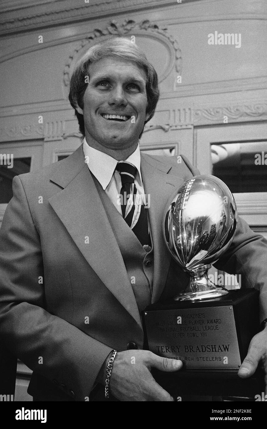 Terry Bradshaw of the Pittsburgh Steelers holds the silver trophy